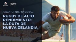 Rugby player in a white jersey dives with the ball toward the right, with a dark blue text banner on the left.
